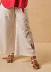 A Model Wearing White Organic Cotton The Jellyfish organic cotton trousers, curated by Only Ethikal